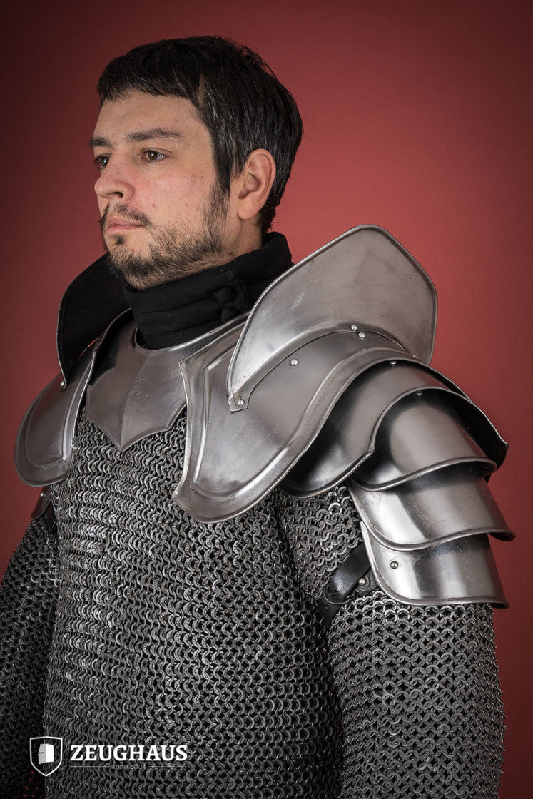 Polished Warrior Pauldrons featuring distinctive blade breakers, crafted from durable leather with a secure attachment system.