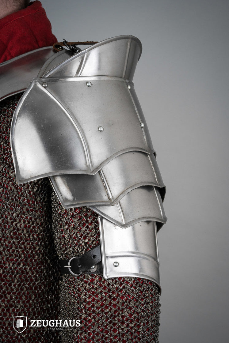 Polished plate pauldrons with blade breakers, featuring flexible design and genuine leather straps for secure fit.