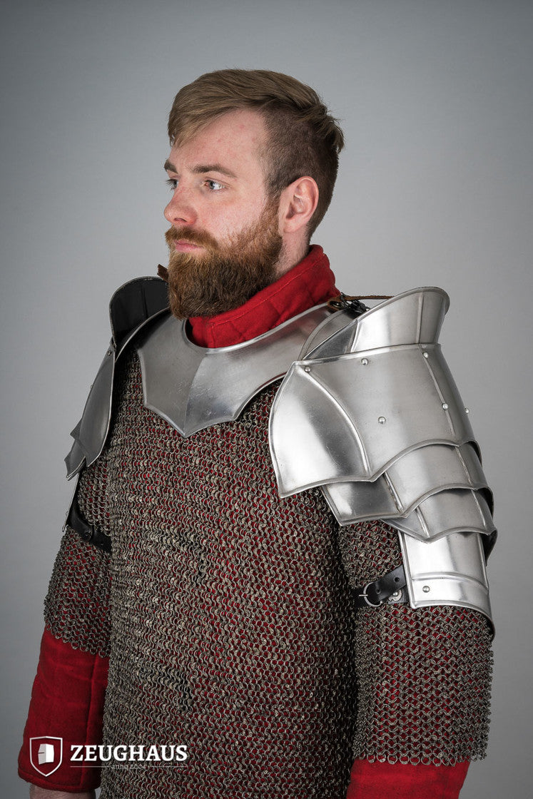 Polished plate pauldrons with blade breakers, featuring flexible design and genuine leather straps for secure fit.