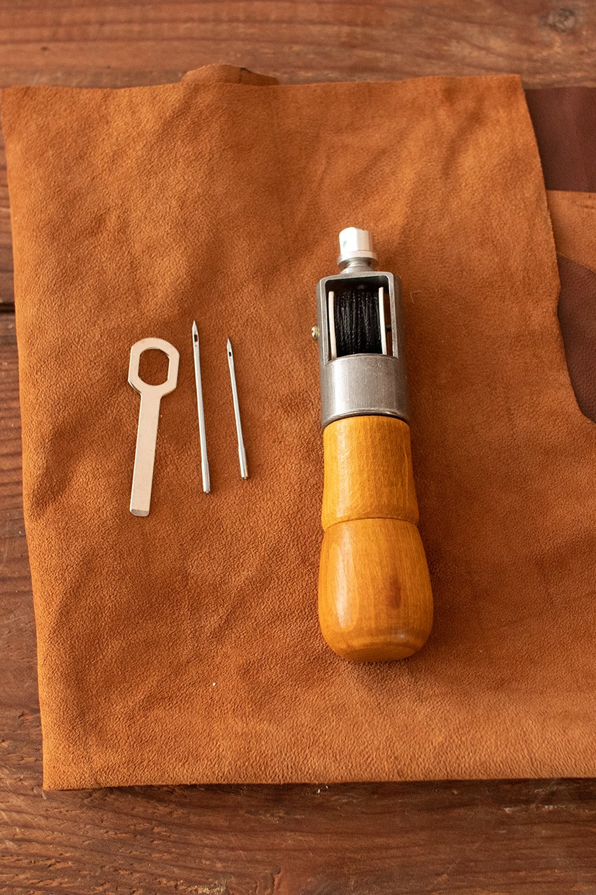 Sewing Awl Kit featuring a sewing needle, wood handle, and yarn coil, ideal for crafting and repairs.