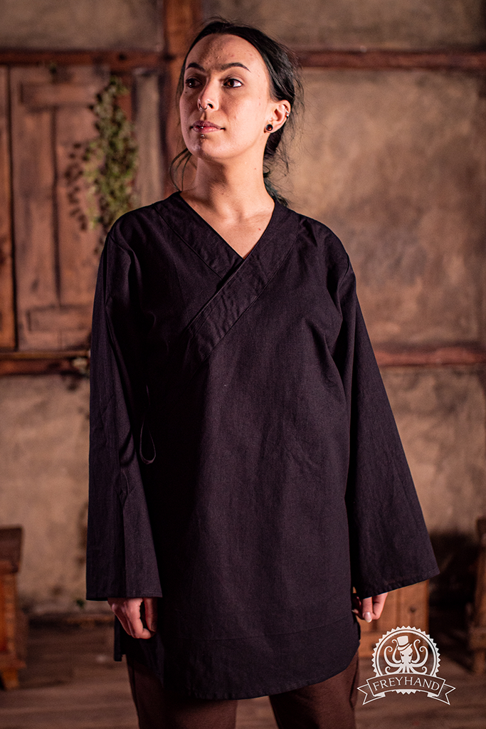 A stylish black shirt with a gender-neutral design, showcasing its excellent fit and quality fabric.