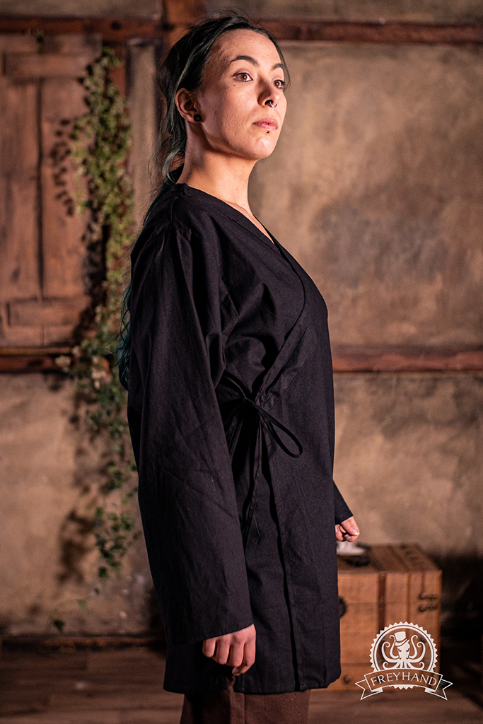 A stylish black shirt with a gender-neutral design, showcasing its excellent fit and quality fabric.