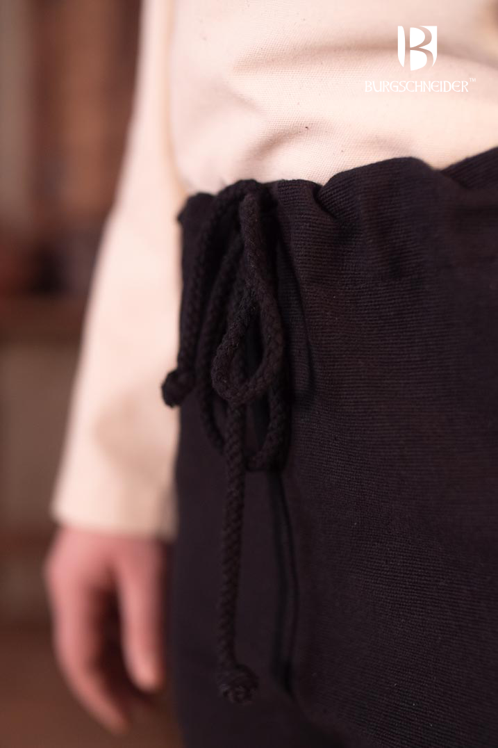 Skjoldehamn Pants Andoya in black, made from 100% cotton, featuring slits at the cuffs and a drawstring waistband for adjustable fit.