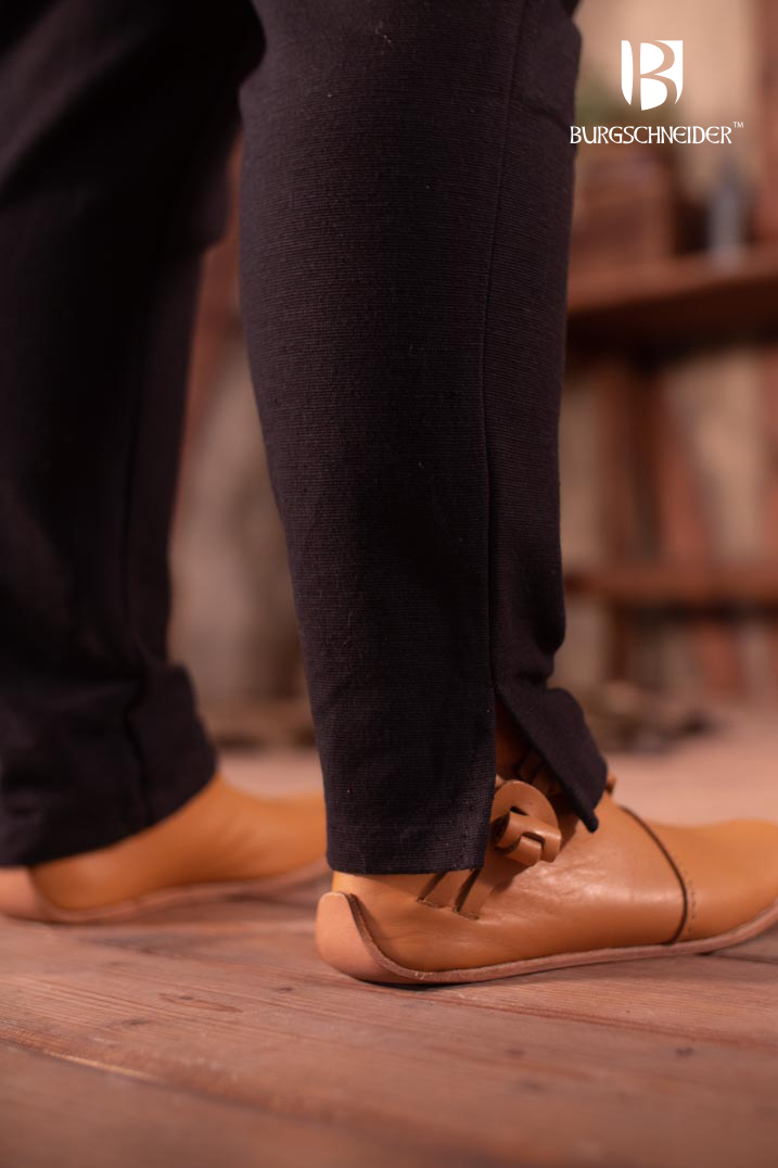 Skjoldehamn Pants Andoya in black, made from 100% cotton, featuring slits at the cuffs and a drawstring waistband for adjustable fit.