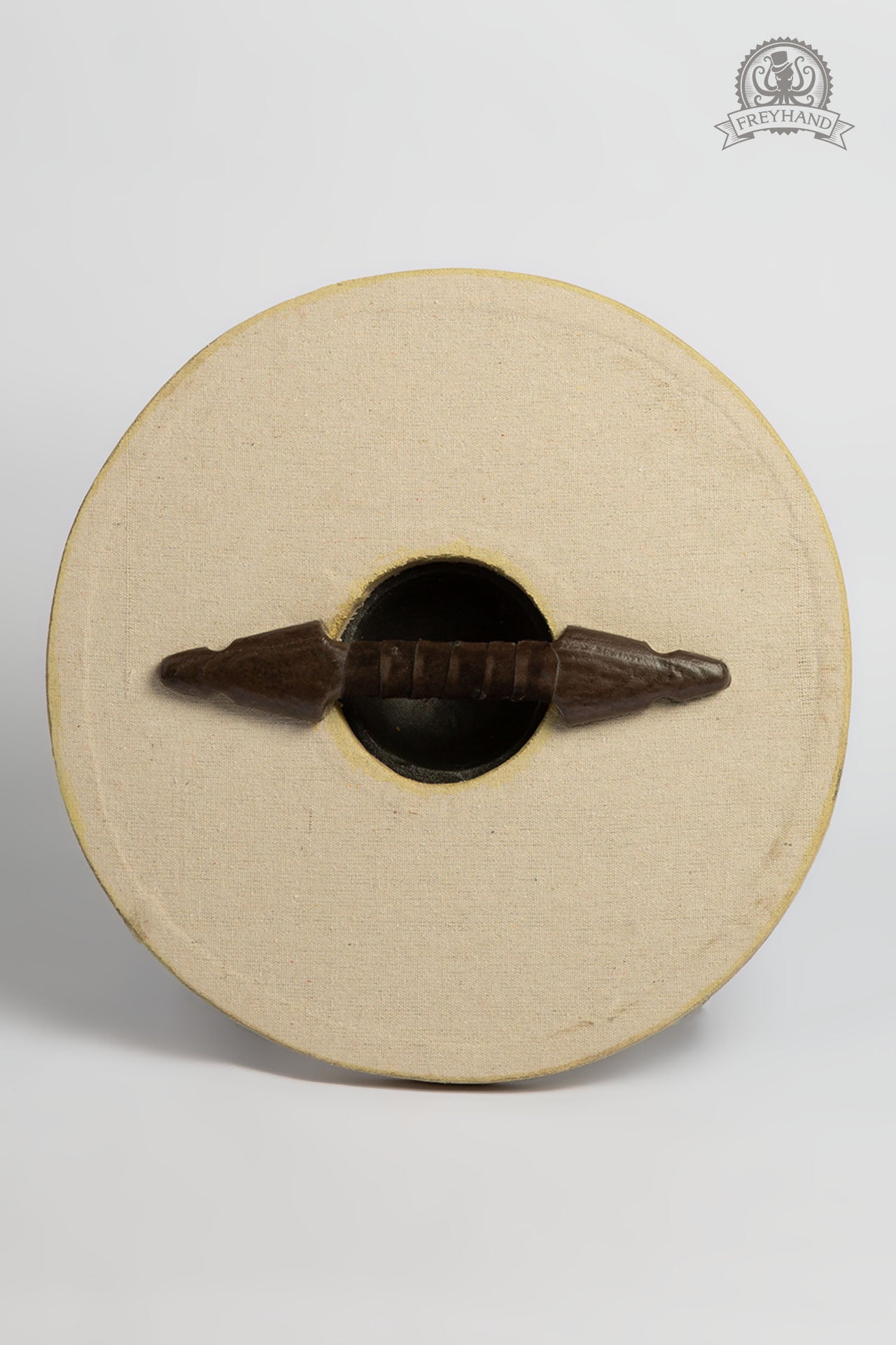 A Small Shield Blank Round made of foam and canvas, featuring a rugged texture, perfect for customization with paint and designs.