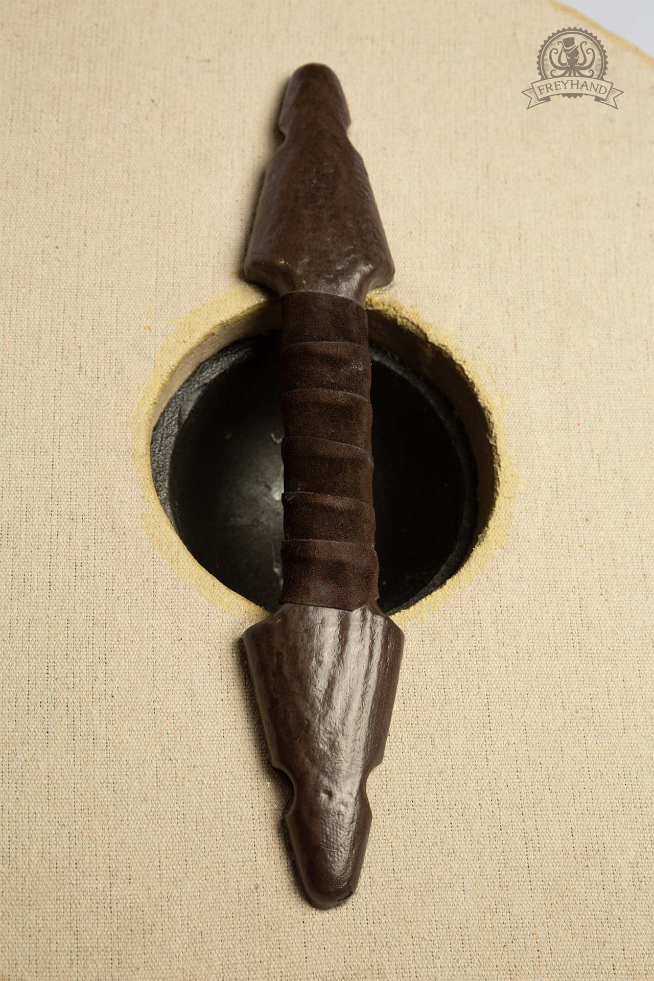 A Small Shield Blank Round made of foam and canvas, featuring a rugged texture, perfect for customization with paint and designs.