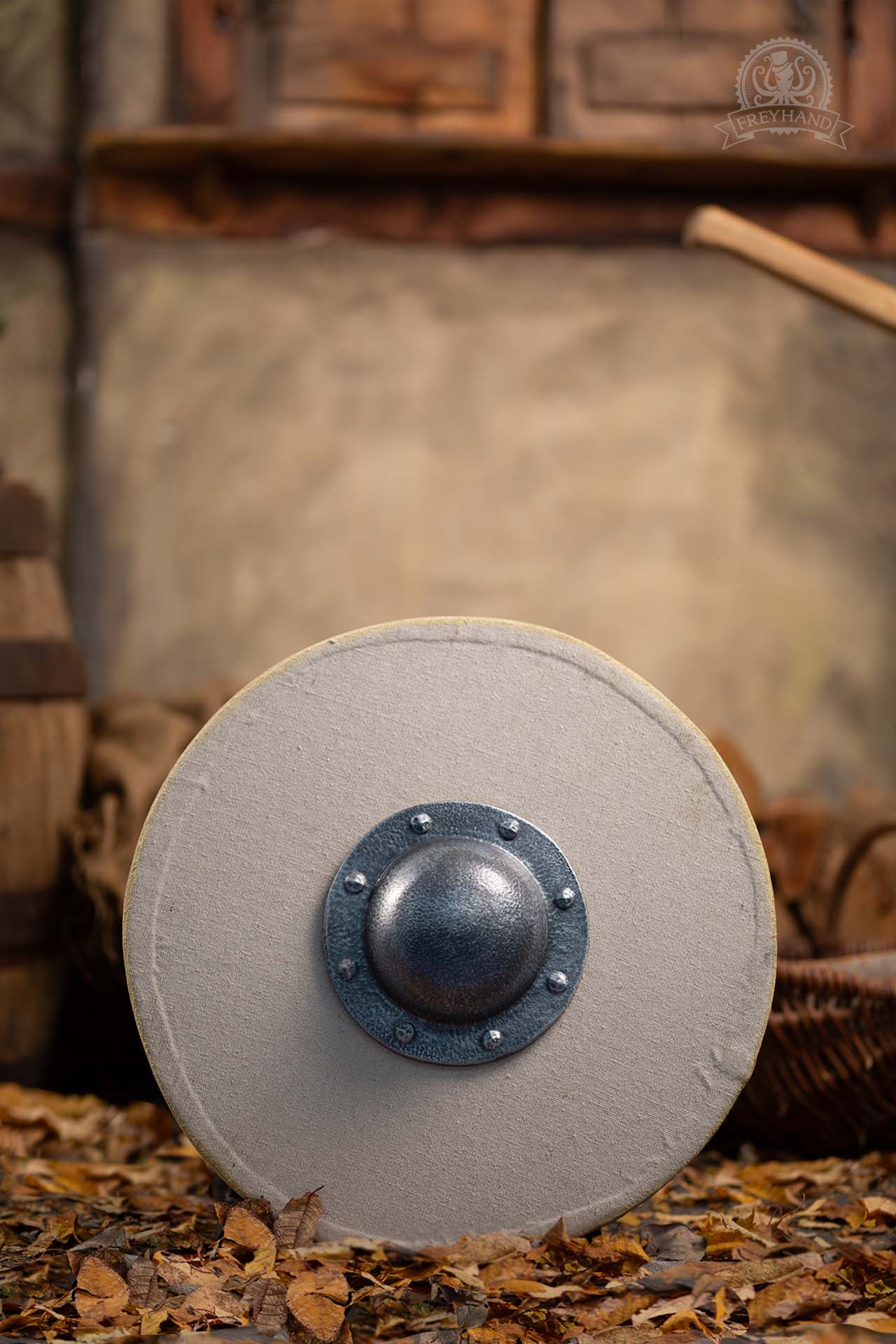 A Small Shield Blank Round made of foam and canvas, featuring a rugged texture, perfect for customization with paint and designs.