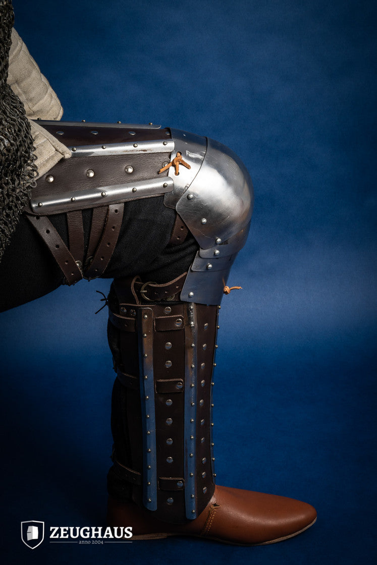 Splinted Leg Armor Brown featuring studded leather and steel strips, designed for historical reenactments and protection during battle.