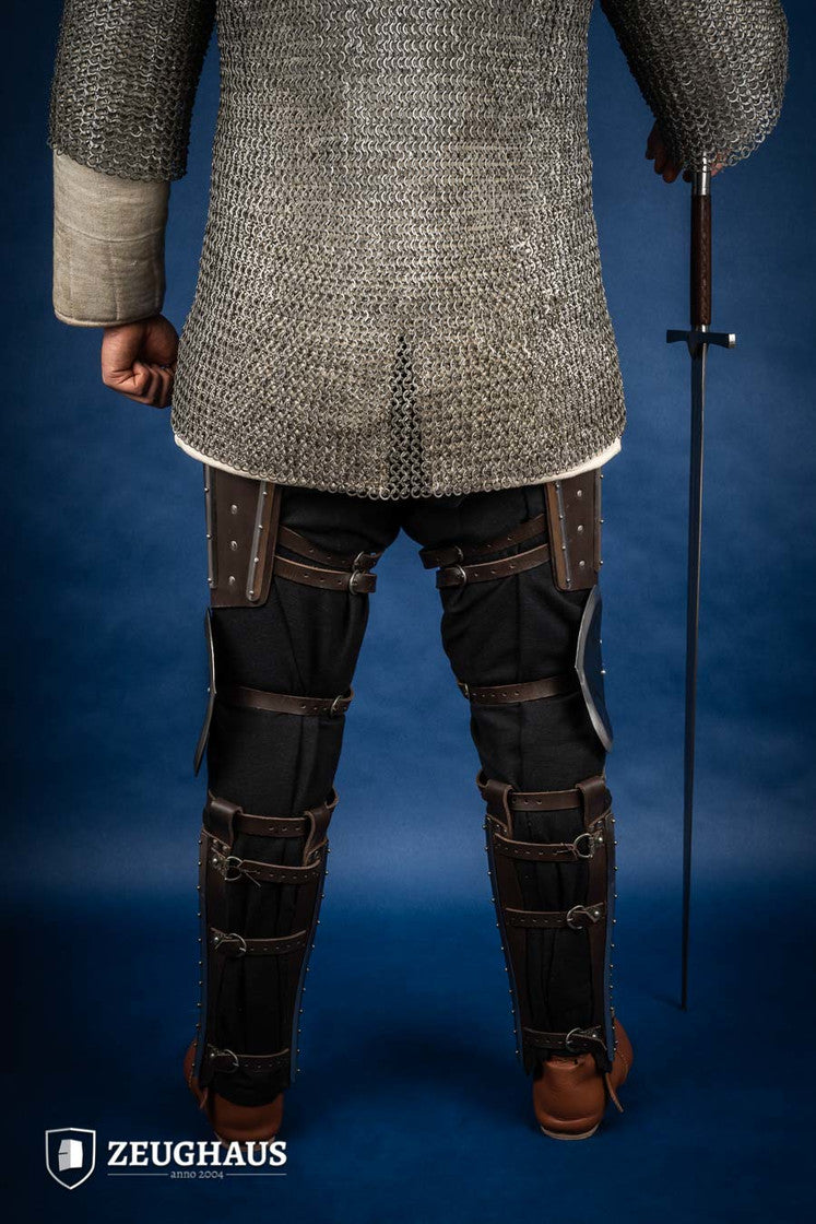 Splinted Leg Armor Brown featuring studded leather and steel strips, designed for historical reenactments and protection during battle.