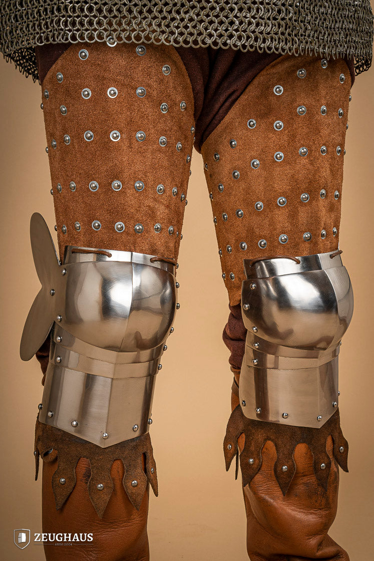 Splinted Leg Armour made of brown suede leather with steel bands, showcasing intricate craftsmanship and medieval design.
