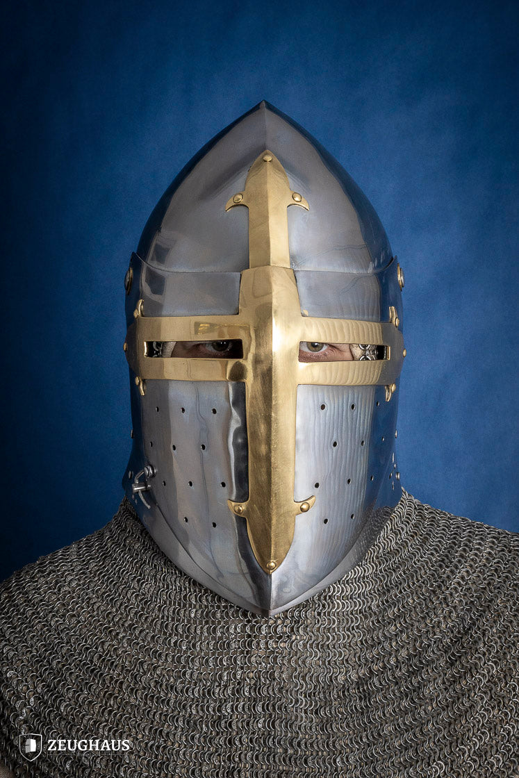 A detailed Sugar Loaf Helmet with a brass visor, showcasing its ornate cross design and steel craftsmanship, perfect for medieval reenactments.