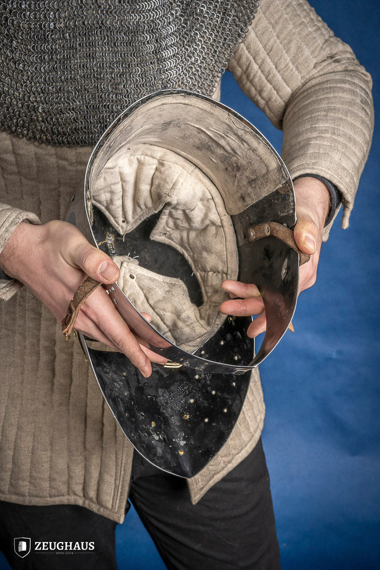 A detailed Sugar Loaf Helmet with a brass visor, showcasing its ornate cross design and steel craftsmanship, perfect for medieval reenactments.
