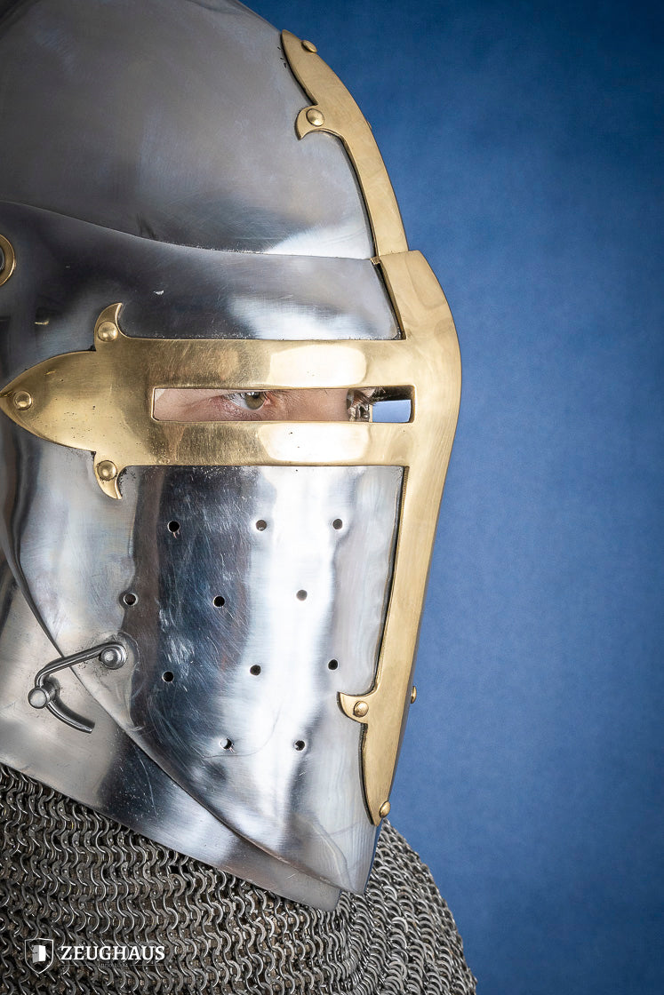 A detailed Sugar Loaf Helmet with a brass visor, showcasing its ornate cross design and steel craftsmanship, perfect for medieval reenactments.