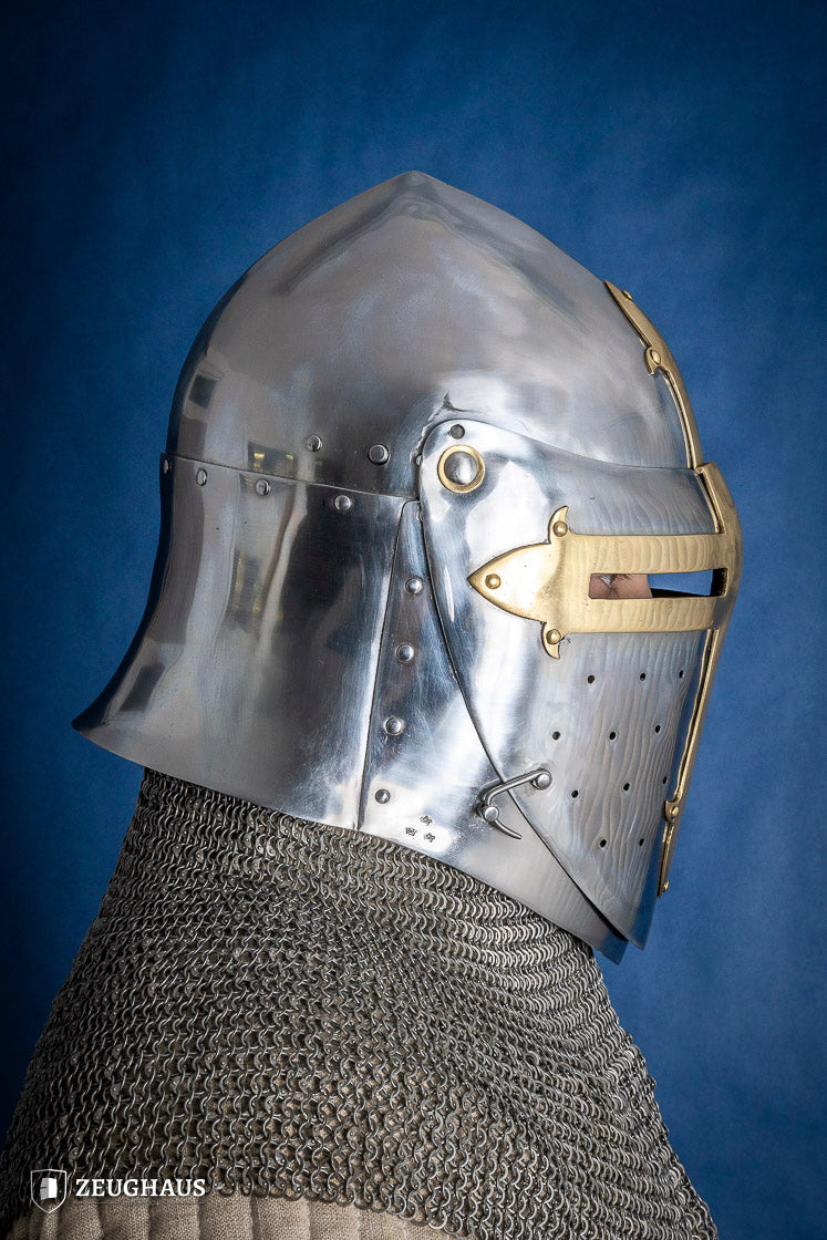A detailed Sugar Loaf Helmet with a brass visor, showcasing its ornate cross design and steel craftsmanship, perfect for medieval reenactments.