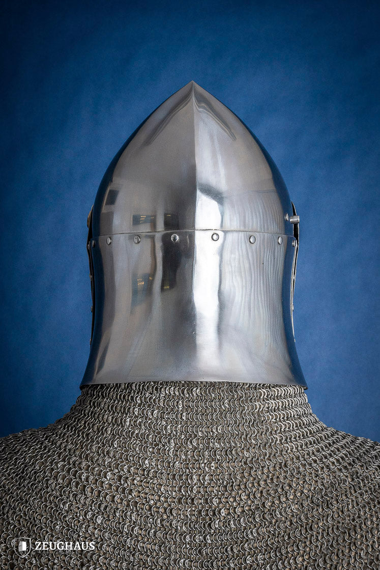 A detailed Sugar Loaf Helmet with a brass visor, showcasing its ornate cross design and steel craftsmanship, perfect for medieval reenactments.
