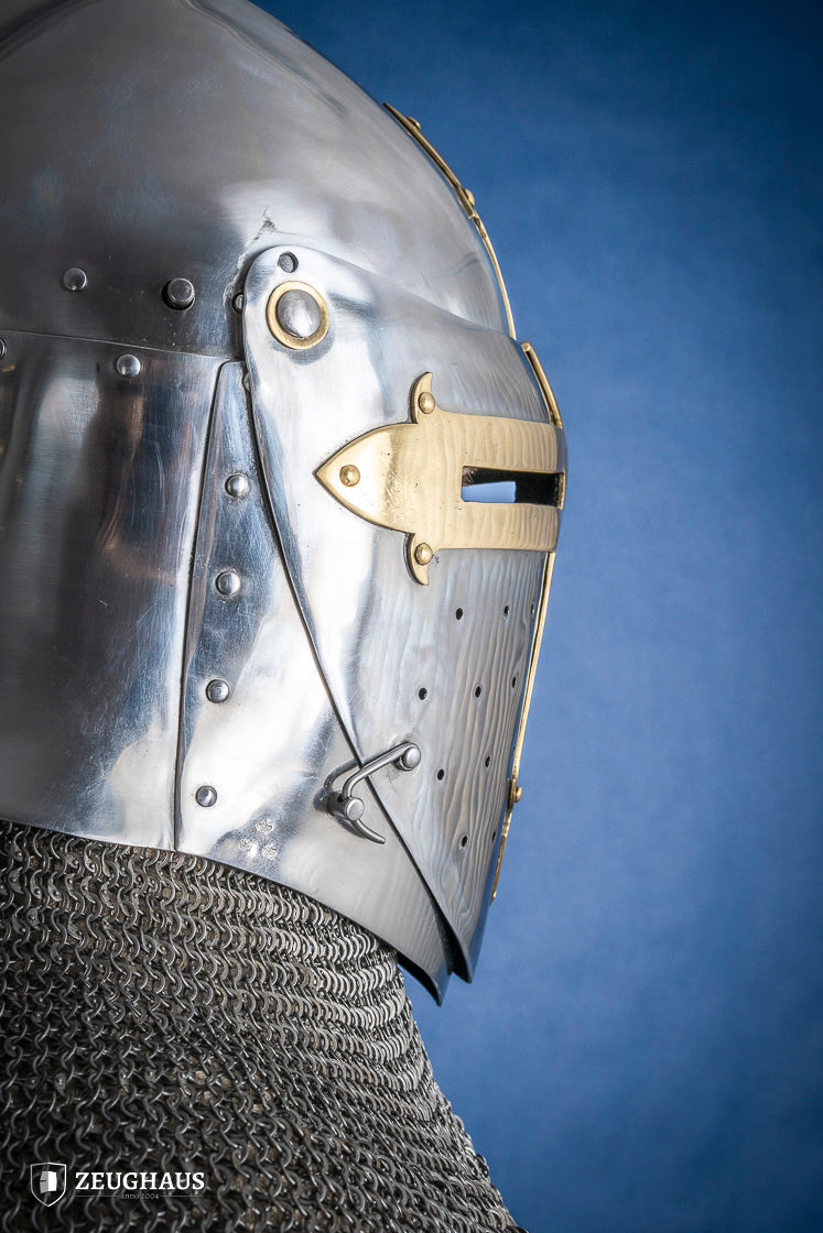 A detailed Sugar Loaf Helmet with a brass visor, showcasing its ornate cross design and steel craftsmanship, perfect for medieval reenactments.
