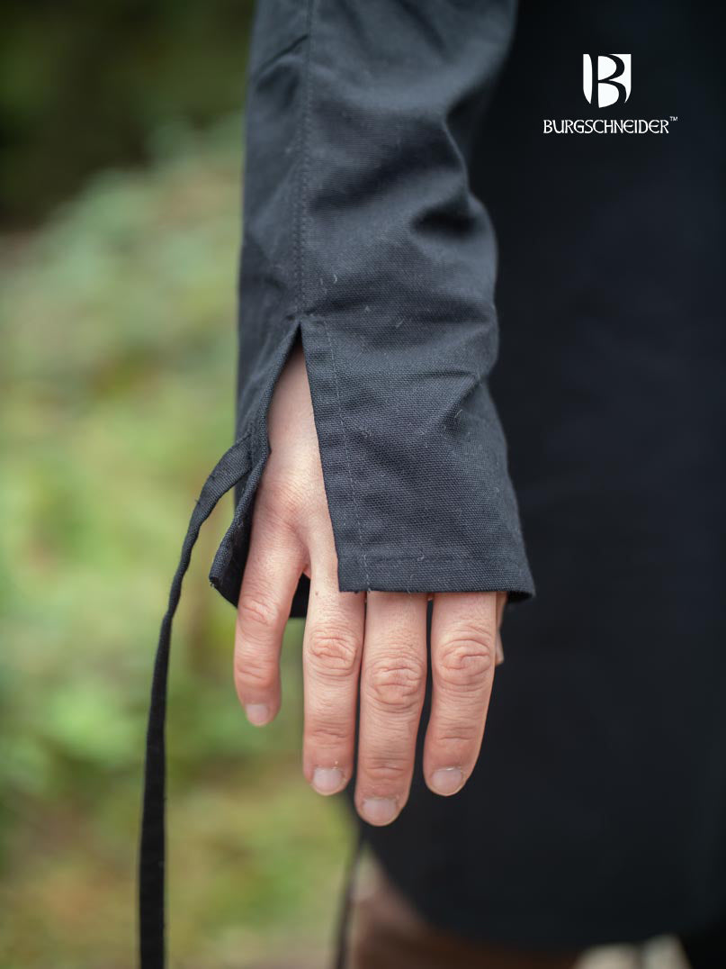 The Thereon Black Tunic featuring long sleeves, quilted shoulders, and a v-shaped neckline, made from 100% cotton.