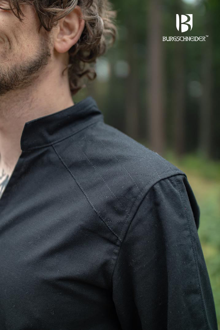 The Thereon Black Tunic featuring long sleeves, quilted shoulders, and a v-shaped neckline, made from 100% cotton.