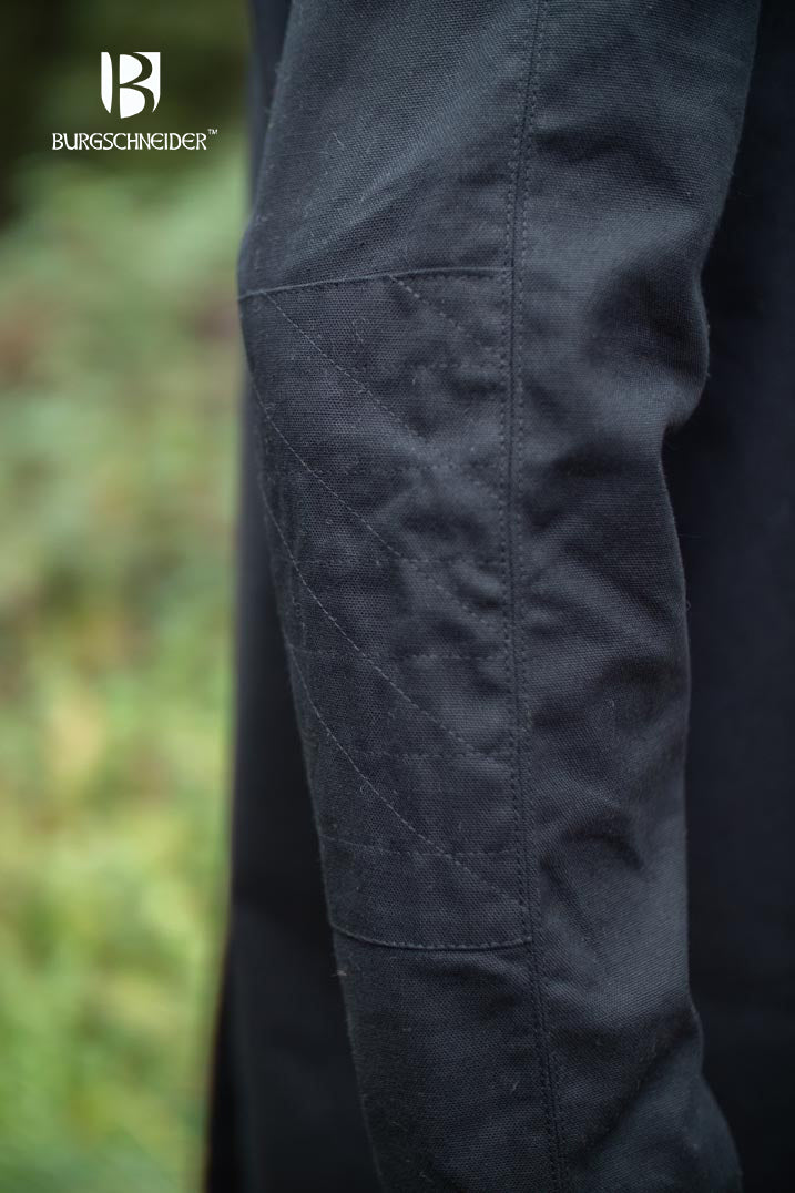 The Thereon Black Tunic featuring long sleeves, quilted shoulders, and a v-shaped neckline, made from 100% cotton.