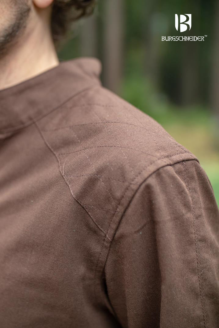 The Thereon Brown Tunic featuring long sleeves, quilted shoulders, and a v-shaped neckline, made from 100% cotton.
