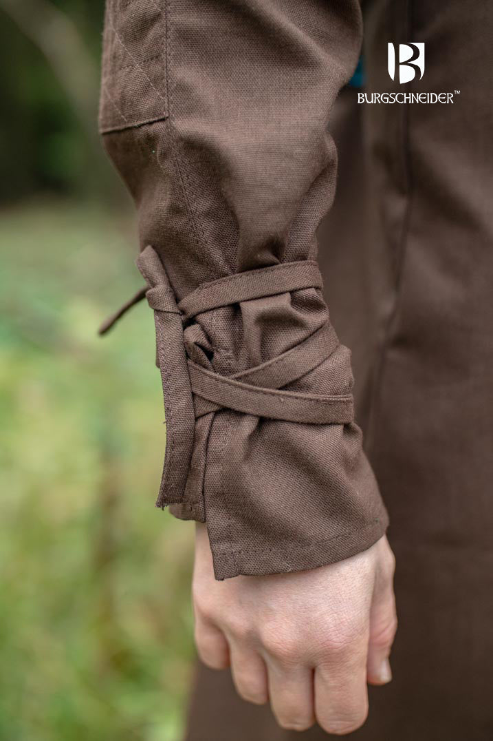 The Thereon Brown Tunic featuring long sleeves, quilted shoulders, and a v-shaped neckline, made from 100% cotton.