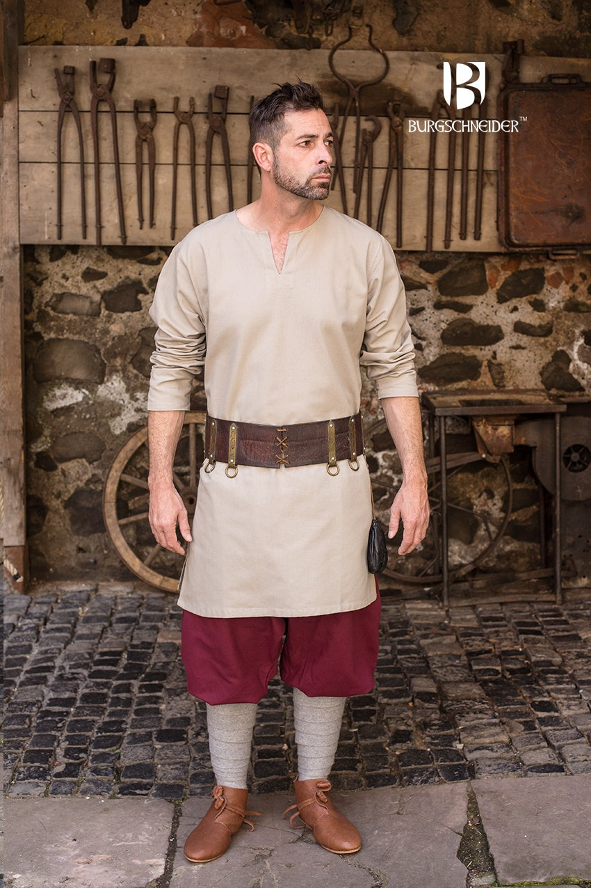 A medieval under tunic made of coarse natural cotton, featuring long sleeves, a round neckline, and side slits for comfort.