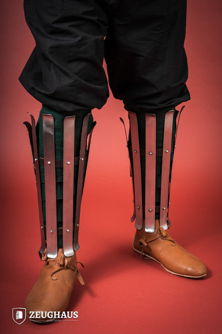 Polished Viking Greaves made from 1.6mm steel, featuring adjustable straps for a flexible fit, showcasing historical craftsmanship.