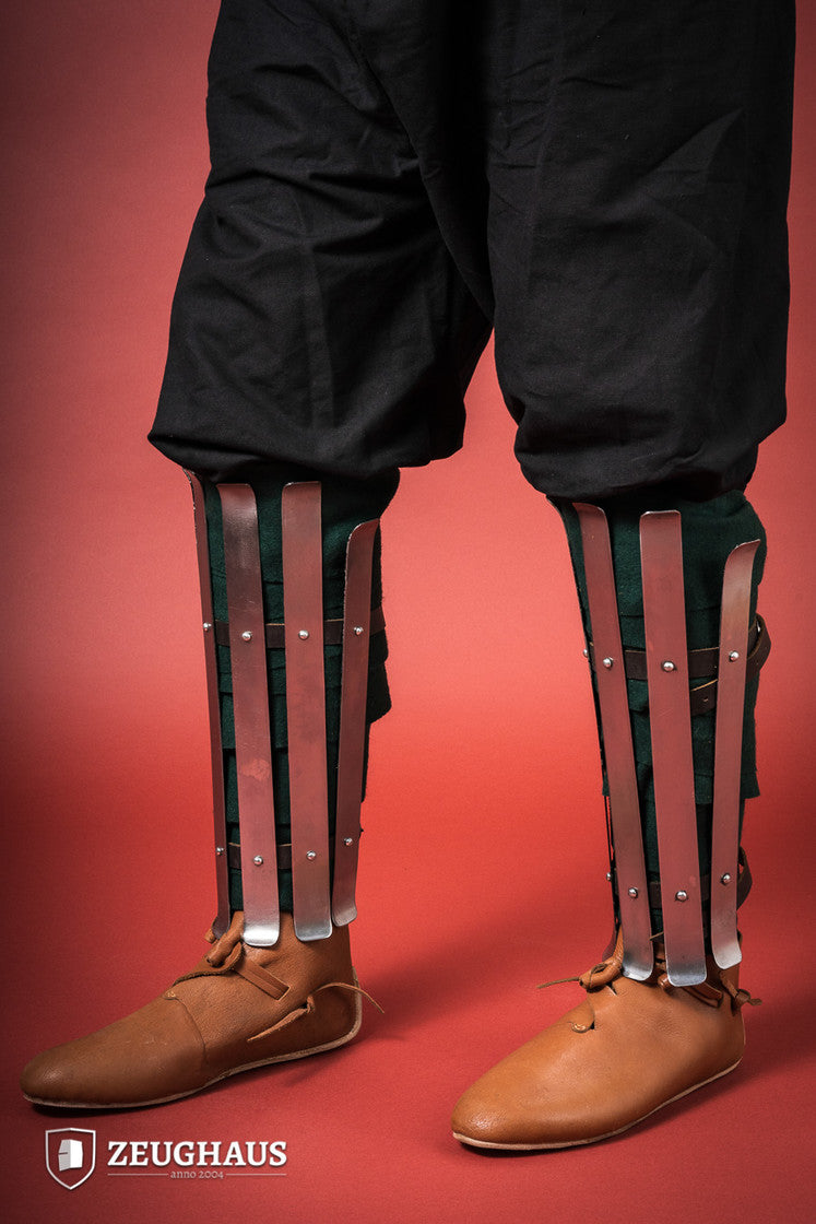 Polished Viking Greaves made from 1.6mm steel, featuring adjustable straps for a flexible fit, showcasing historical craftsmanship.