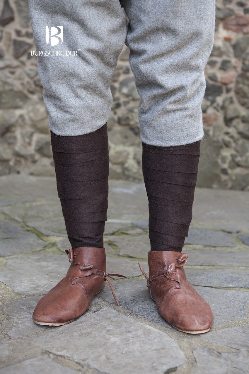A pair of Wool Winingas Aki Brown, showcasing their traditional design and rich brown color, perfect for historical attire.