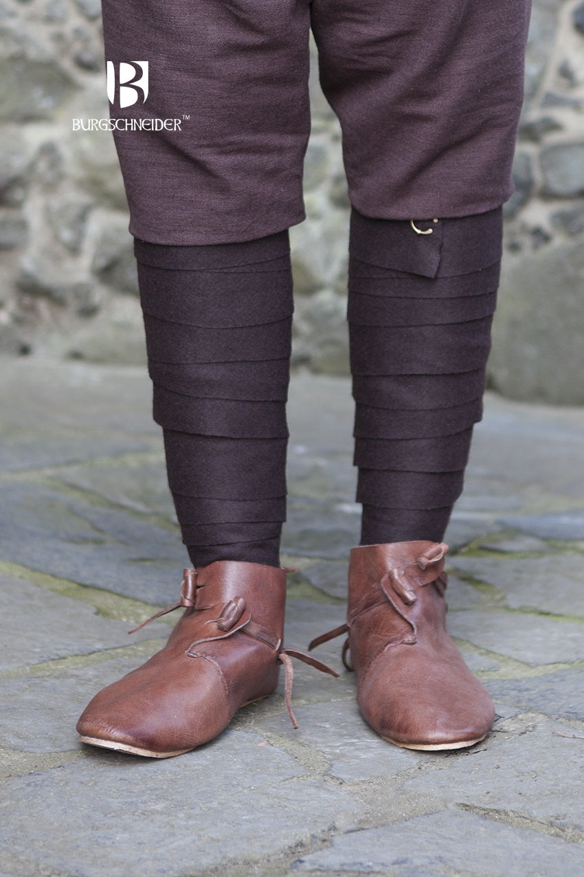 A pair of Wool Winingas Aki Brown, showcasing their traditional design and rich brown color, perfect for historical attire.