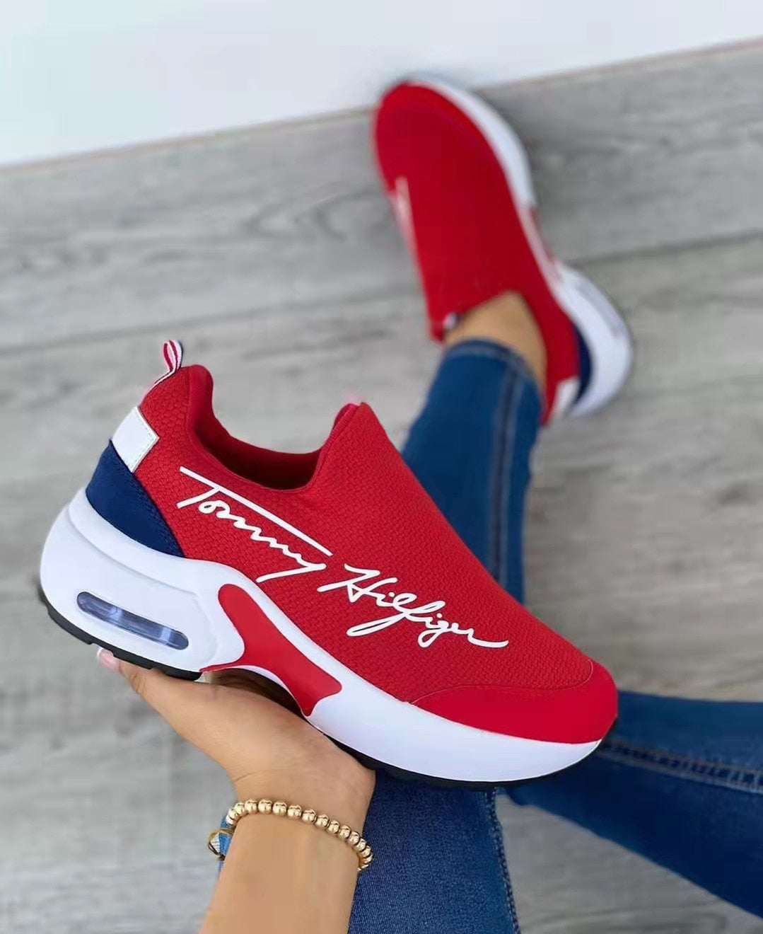 A pair of stylish 2022 Fashion Casual Breathable Wedges Ladies Walking Sneakers in a chic design, showcasing their breathable material and wedge heel.