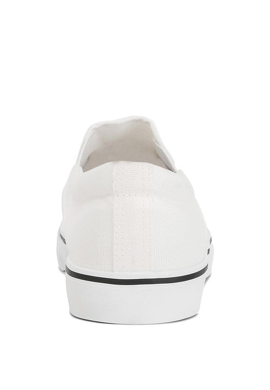 Merlin Canvas Slip On Sneakers in classic white, featuring elastic gussets and a padded collar for comfort.