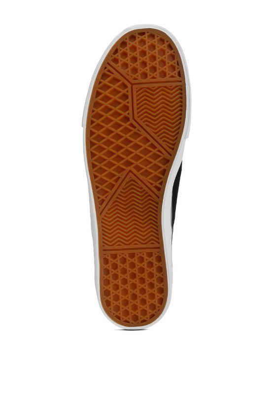 Merlin Canvas Slip On Sneakers in classic white, featuring elastic gussets and a padded collar for comfort.