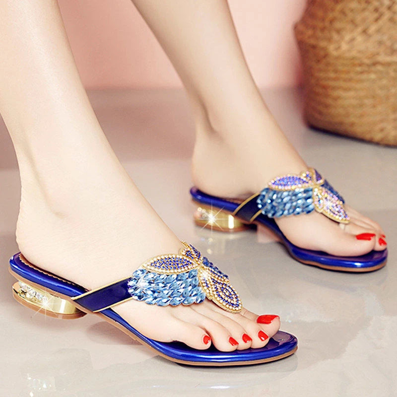 Stylish women's rhinestone sandals featuring a sleek design and comfortable slip-on style, perfect for summer outings.