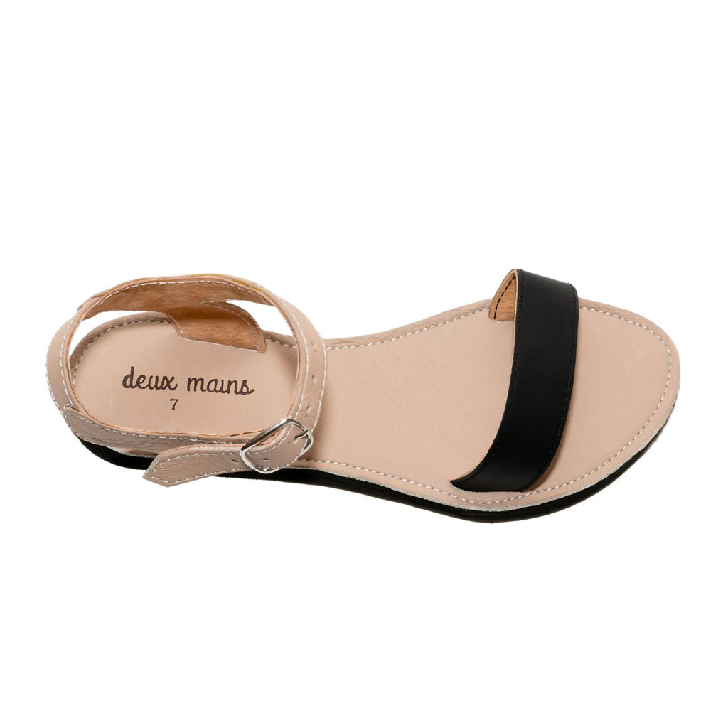 A pair of Simple Ankle Strap Sandals in classic black and hand-painted white canvas, showcasing their elegant design and supple leather material.