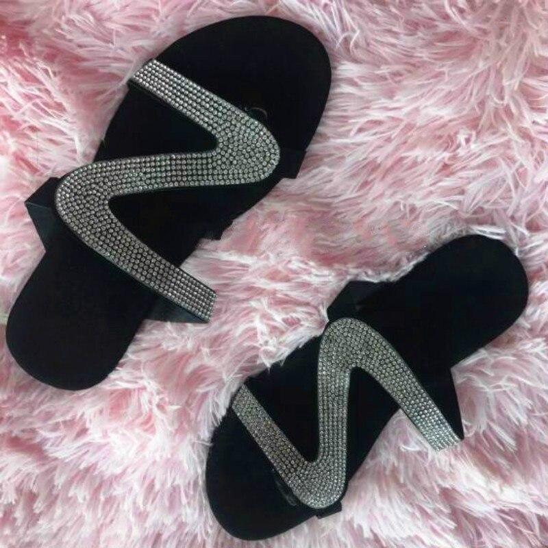 A pair of stylish 2021 Bling Bling Slides for women, featuring a shimmering design perfect for summer beach outings, displayed on a sandy background.