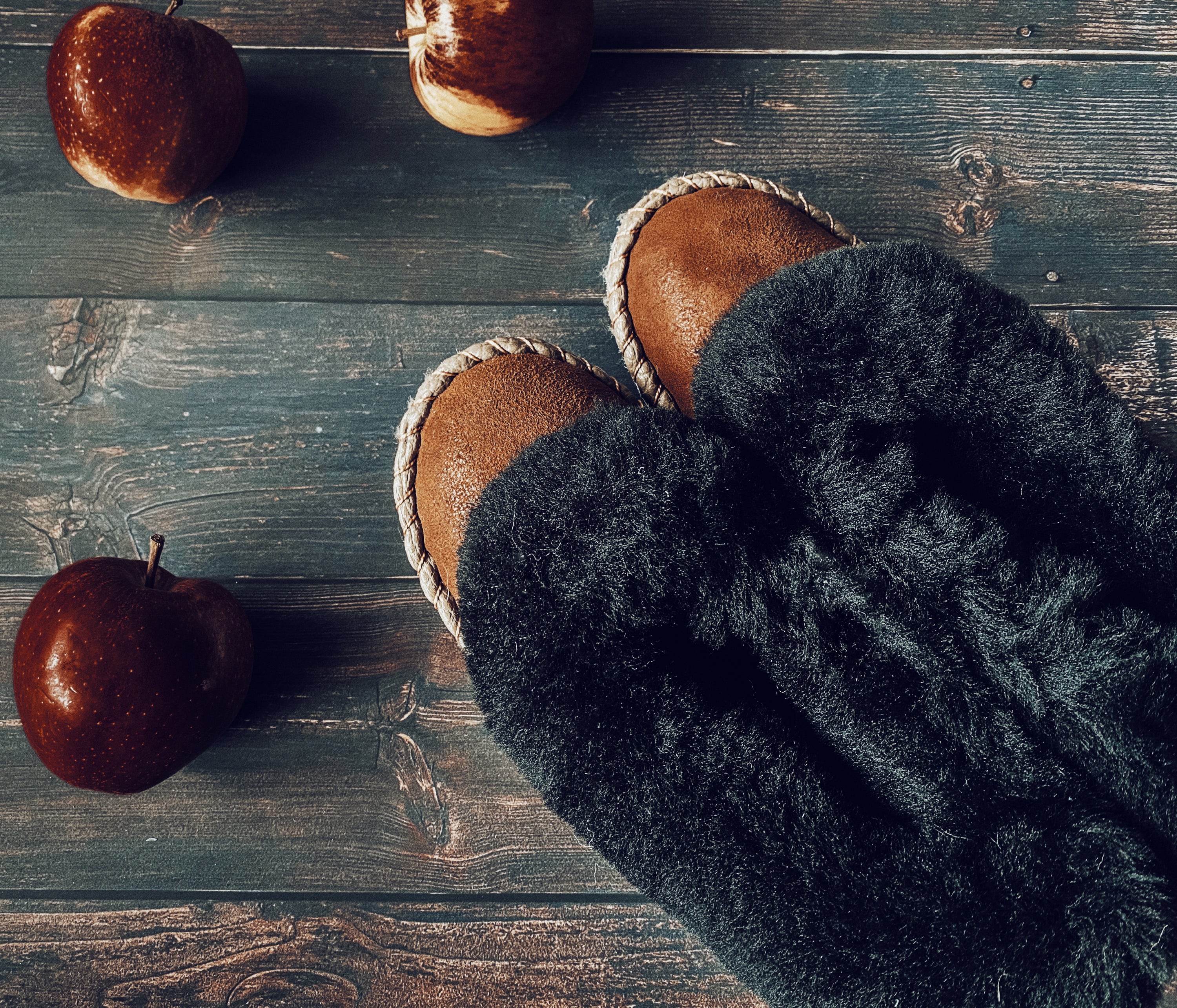 Brown Range Sheepskin Slippers featuring a fluffy fur cuff and genuine leather sole, showcasing their handcrafted quality and cozy design.