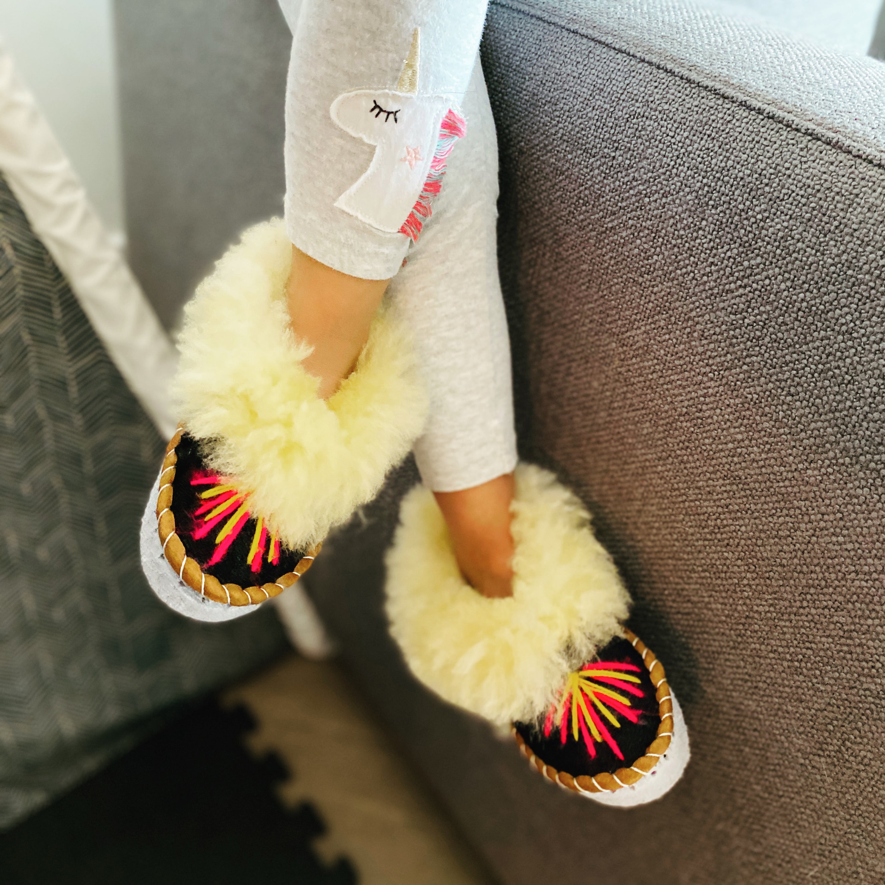 Colorful children's embroidered sheepskin slippers with fluffy fur cuff, handmade in Poland.