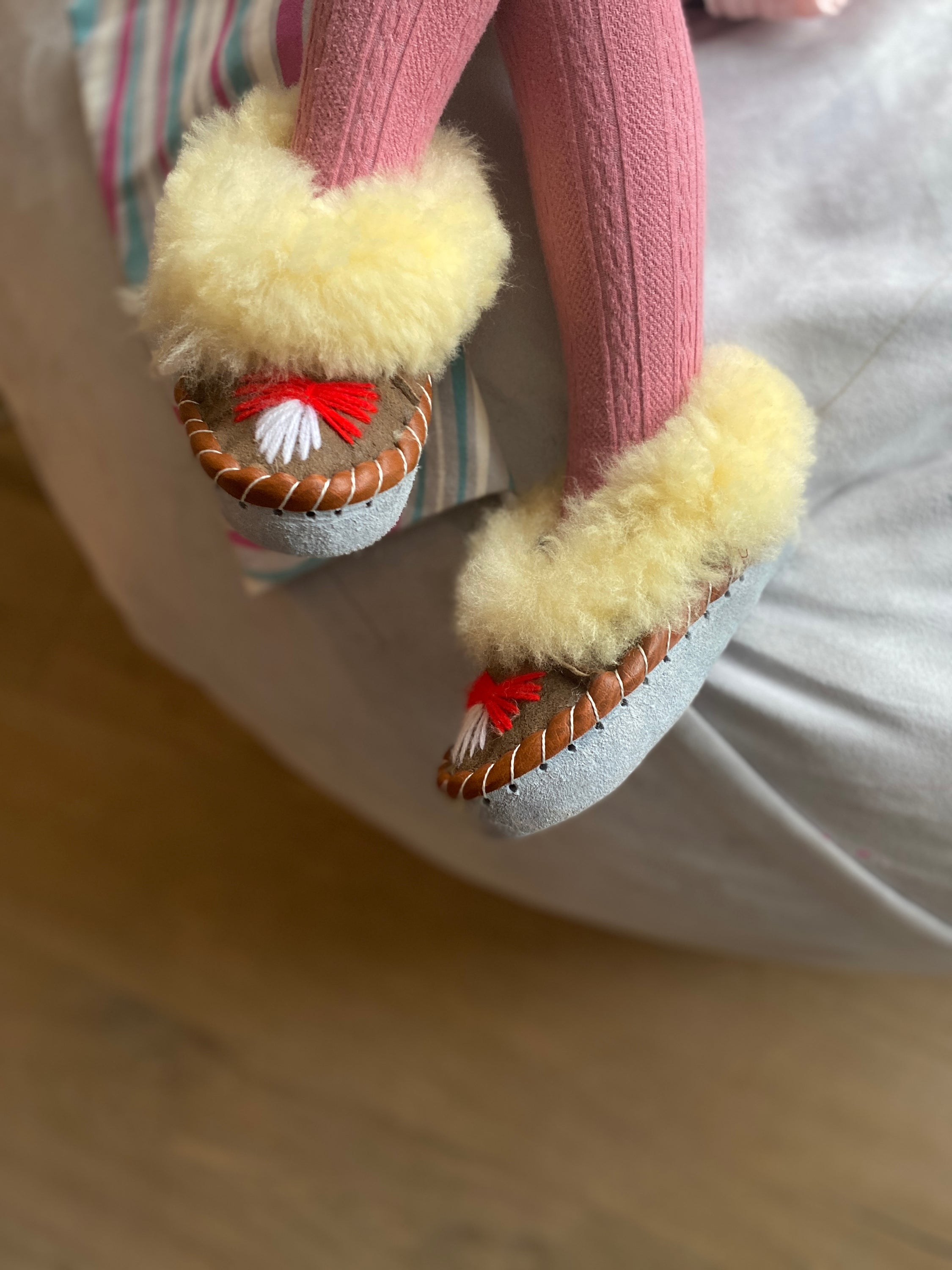 Colorful children's embroidered sheepskin slippers with fluffy fur cuff, handmade in Poland.