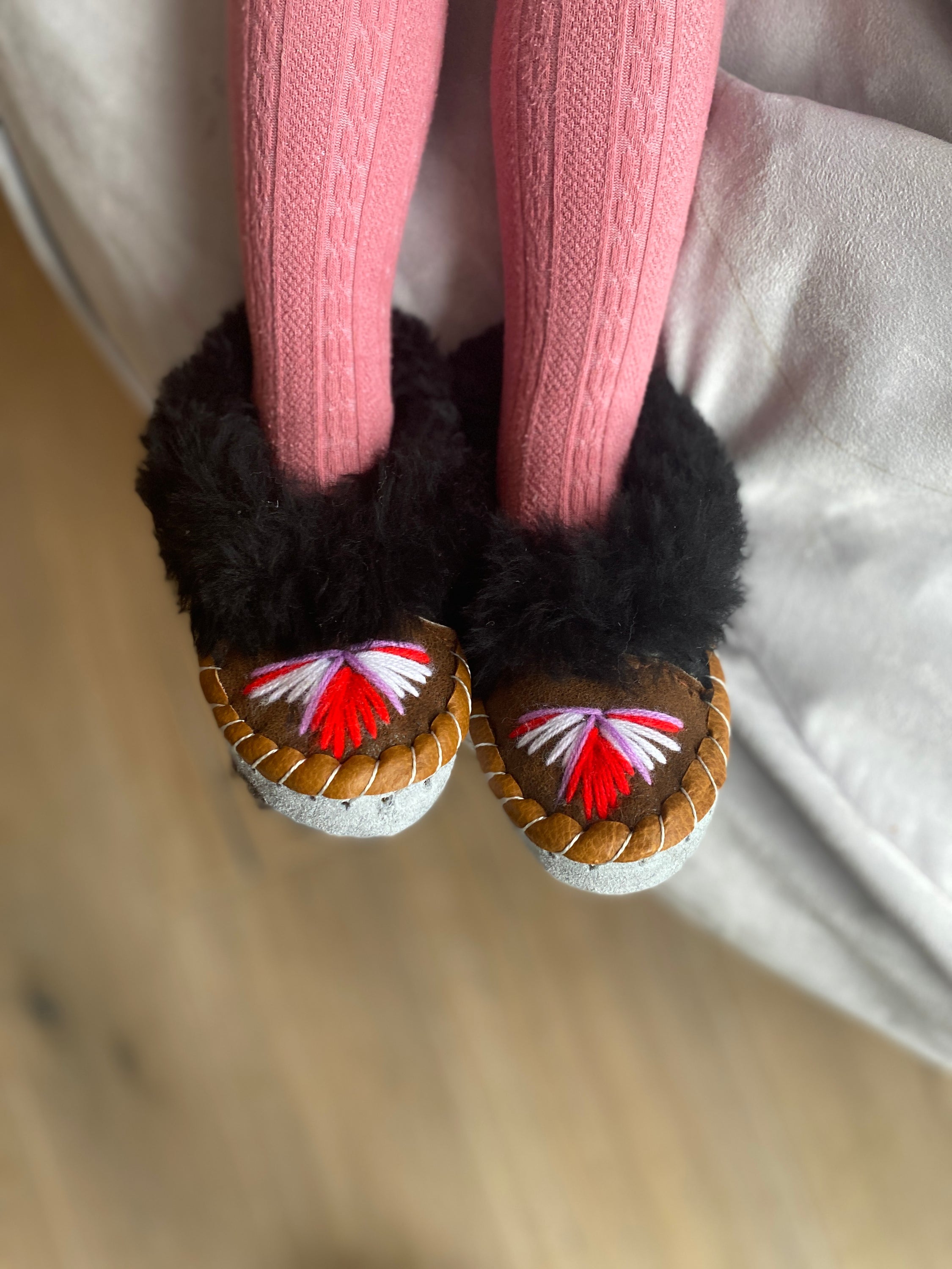 Colorful children's embroidered sheepskin slippers with fluffy fur cuff, handmade in Poland.