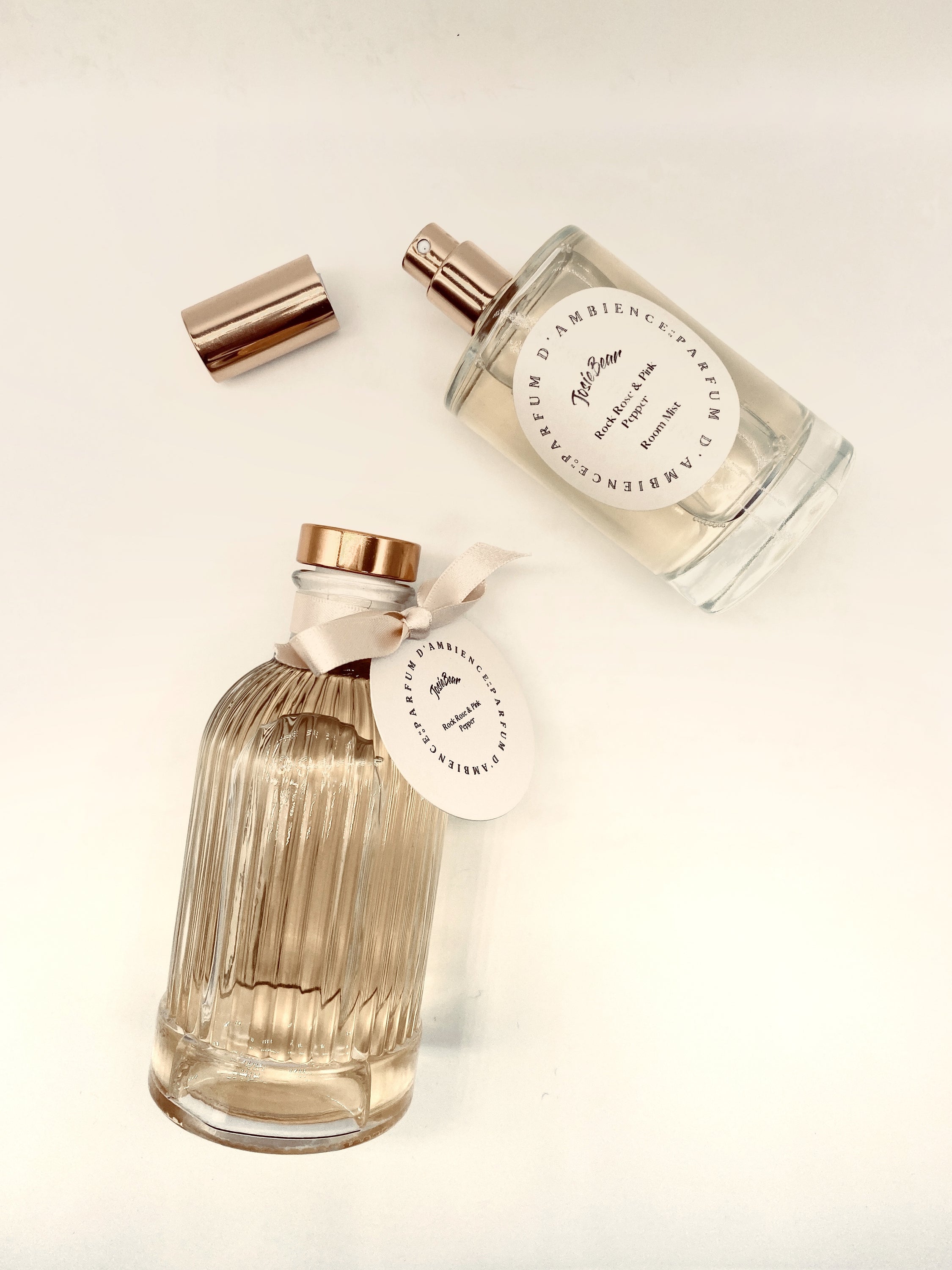 Dark Amber & Sandalwood Room Mist in an elegant glass bottle, showcasing its rich earthy color and luxurious design.