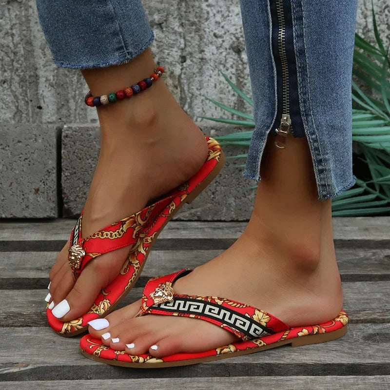 A pair of stylish Designer slippers from the sexikinis swim collection featuring vibrant prints, perfect for summer lounging and beach outings.