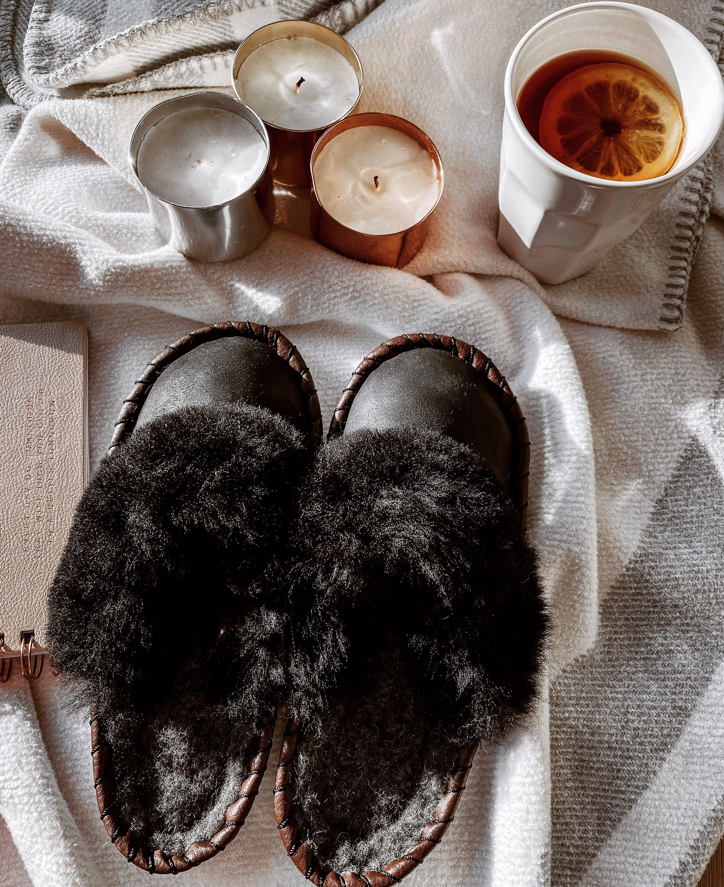 Onyx Black Slip Ons featuring black leather and fur cuff, showcasing luxurious craftsmanship and cozy design.
