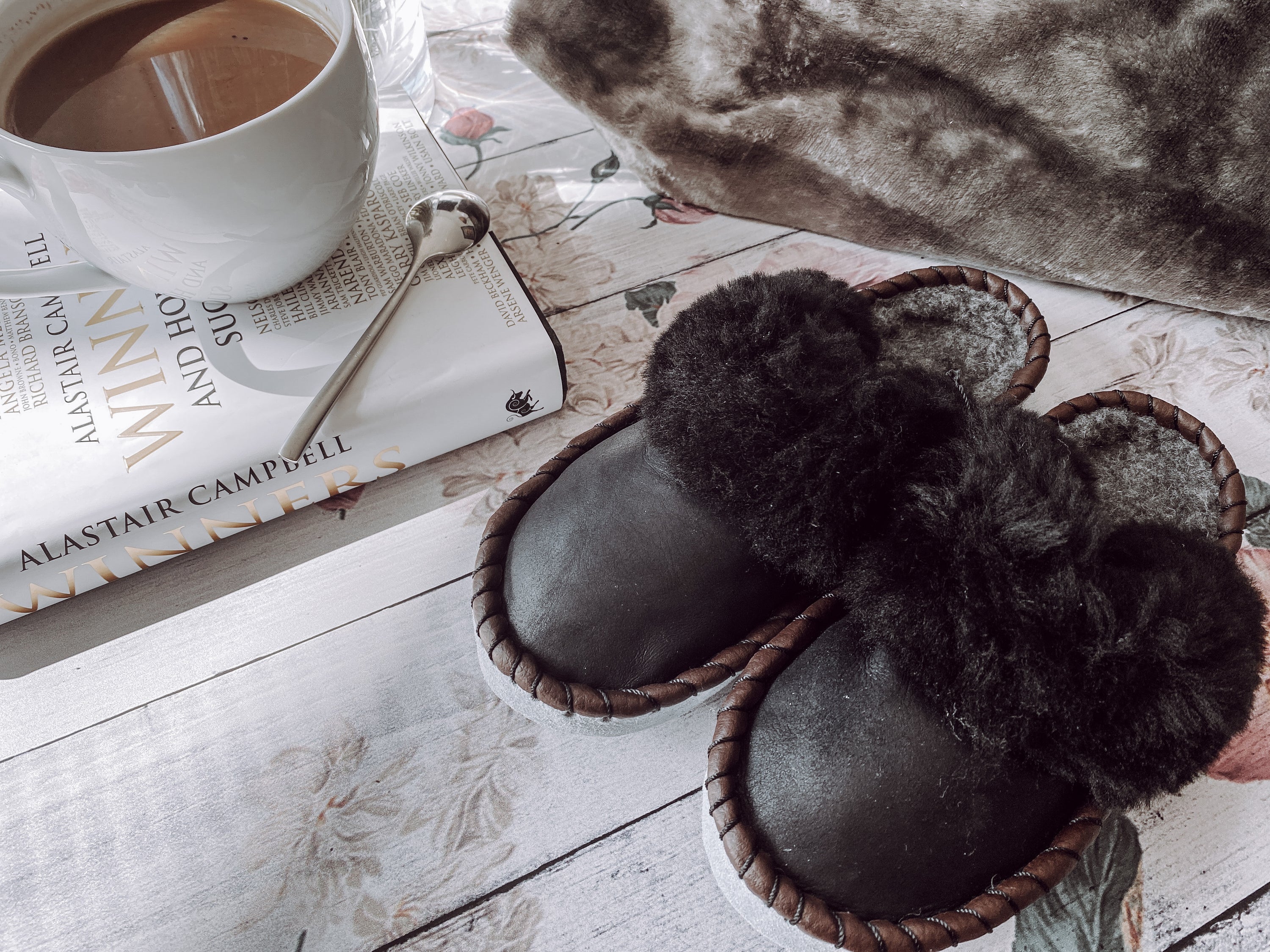 Onyx Black Slip Ons featuring black leather and fur cuff, showcasing luxurious craftsmanship and cozy design.