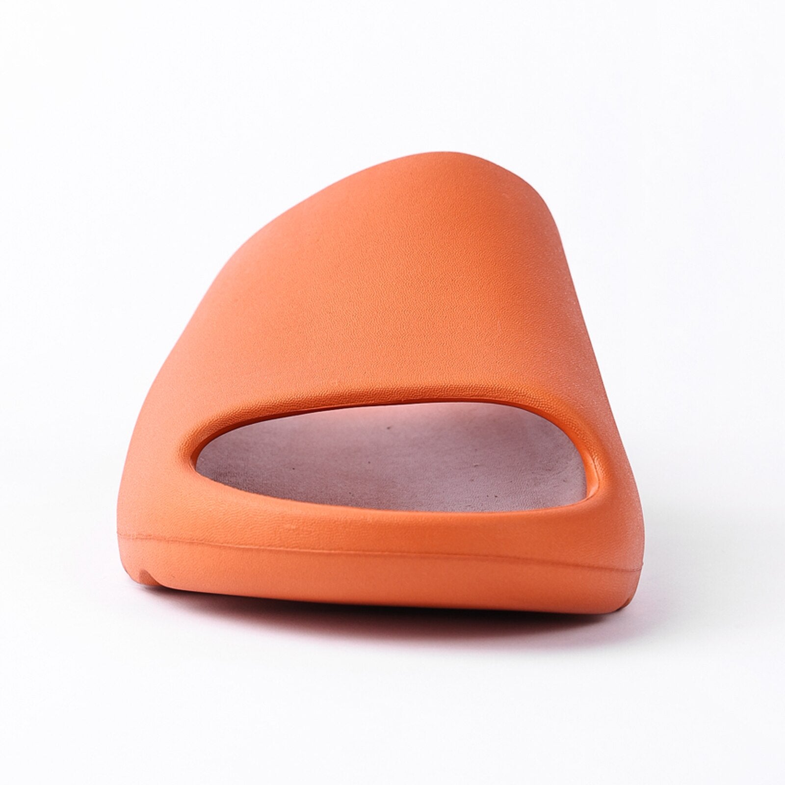 A pair of orange chunky platform pillow slides for women, featuring an open toe design and a cushioned insole, perfect for casual wear and shower use.