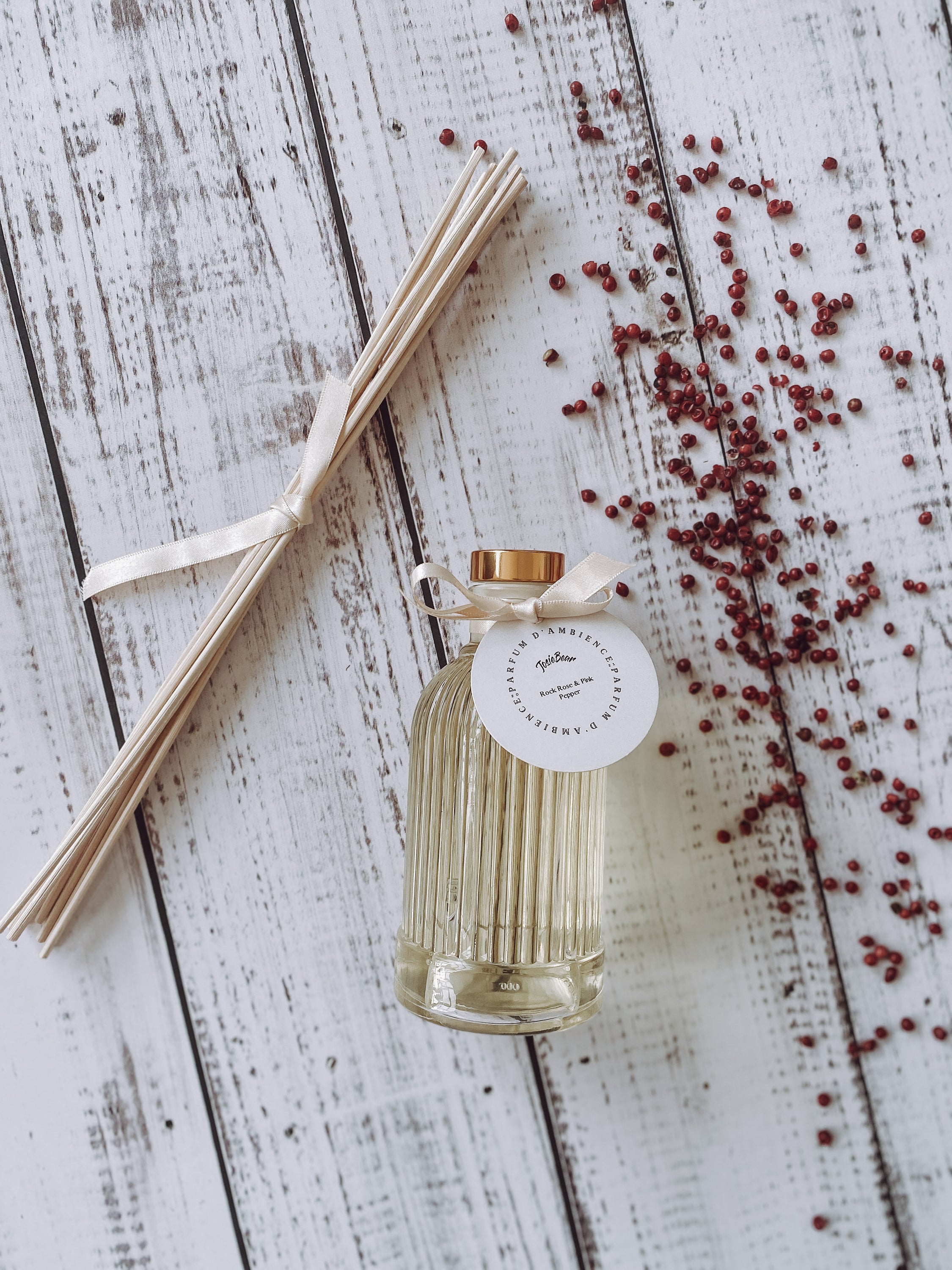 Rock Rose & Pink Pepper Reed Diffuser in a stylish glass bottle with rattan reed sticks, showcasing a floral and spicy aroma.
