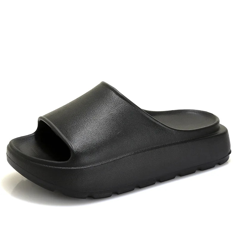 A pair of stylish Soft Thick Sole Slides in a modern design, made from soft EVA material, perfect for summer outings.