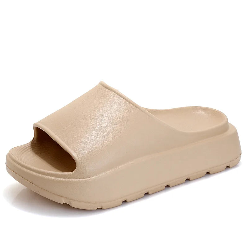 A pair of stylish Soft Thick Sole Slides in a modern design, made from soft EVA material, perfect for summer outings.