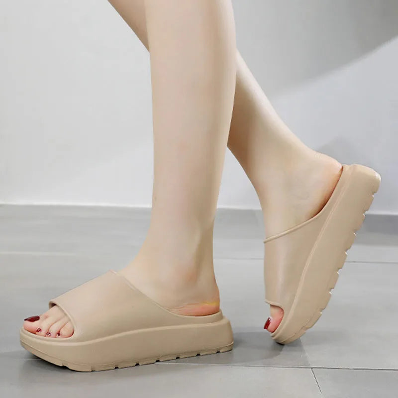 A pair of stylish Soft Thick Sole Slides in a modern design, made from soft EVA material, perfect for summer outings.