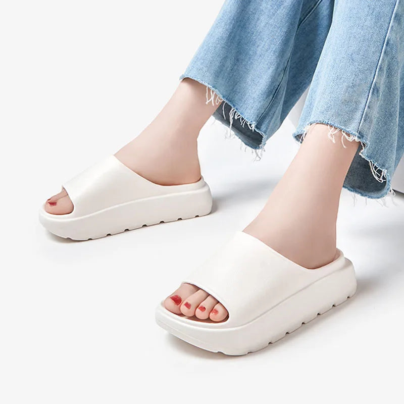 A pair of stylish Soft Thick Sole Slides in a modern design, made from soft EVA material, perfect for summer outings.